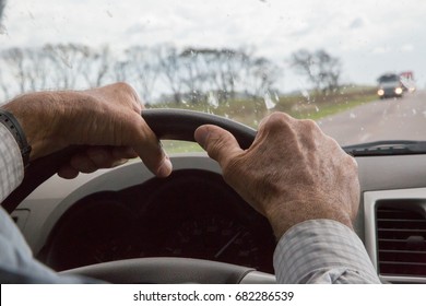 Farmer driving in the freeway. hands on the steering wheel 