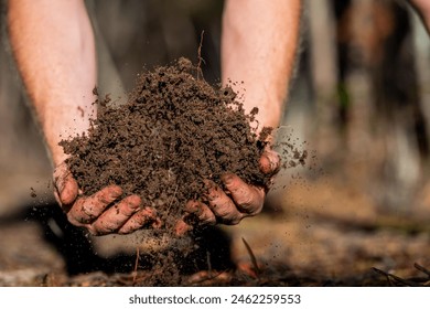 farmer hold soil in hands monitoring soil health on a farm.in australia - Powered by Shutterstock