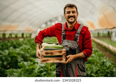 Farmer holding a wooden box full of fresh vegetables - Powered by Shutterstock