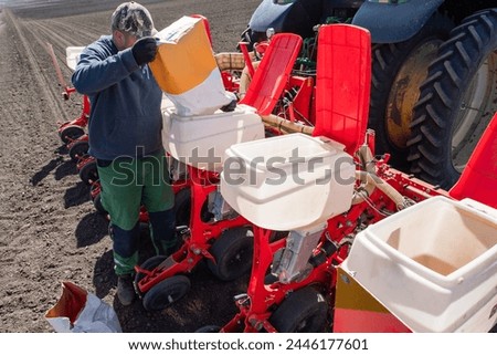 Farmer loading seed to seeding machine