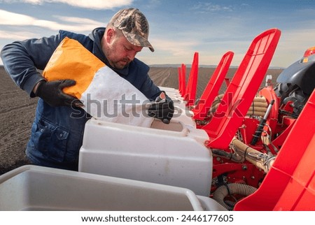 Farmer loading seed to seeding machine