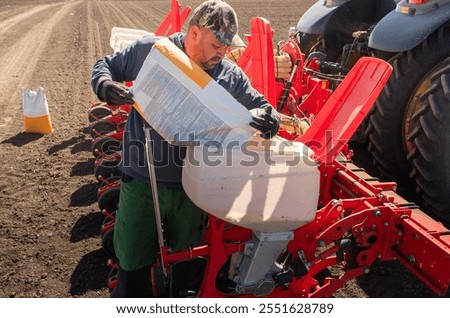 Farmer loading seed to seeding machine