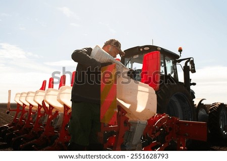 Farmer loading seed to seeding machine