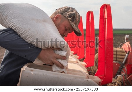 Farmer loading seed to seeding machine