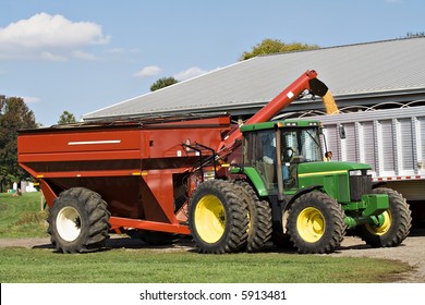 Farmer Loads Grain - Corn From Field Into Semi Truck For Transport.