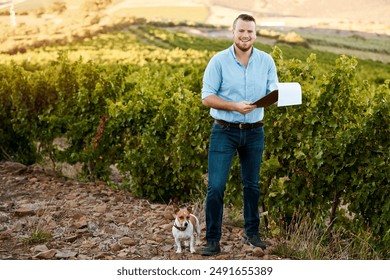 Farmer, man and clipboard with notes in vineyard, dog or portrait for growth, development or progress in summer. Person, checklist and grapes with sustainability, smile and quality control in Spain - Powered by Shutterstock