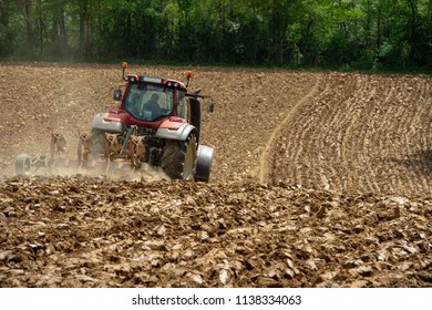 Farmer on tractor plow field, France, Europe