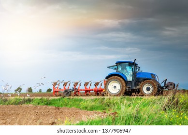 
farmer plowing his fields - Shutterstock ID 1377906947