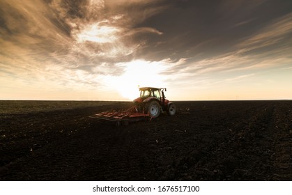 Farmer preparing his field in a tractor ready for spring. - Shutterstock ID 1676517100