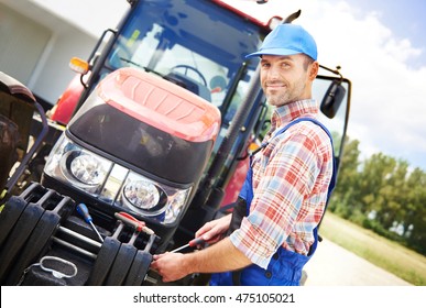 Farmer Repairing His Big Tractor