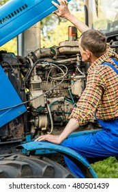 Farmer Repairing A Tractor. Mechanic.