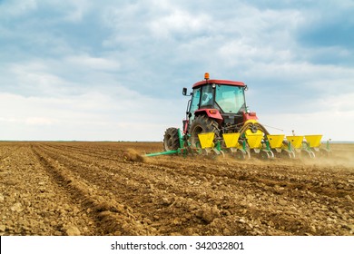 Farmer Seeding Crops At Field