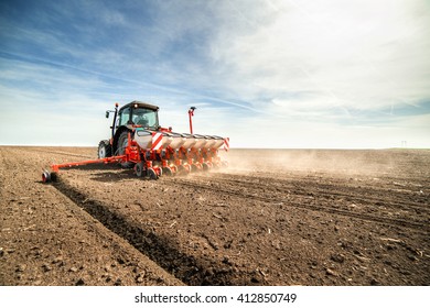 Farmer Seeding Crops At Field