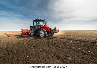 Farmer Seeding Crops At Field