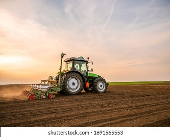 Farmer seeding, sowing crops at field. Sowing is the process of planting seeds in the ground as part of the early spring time agricultural activities. - Shutterstock ID 1691565553