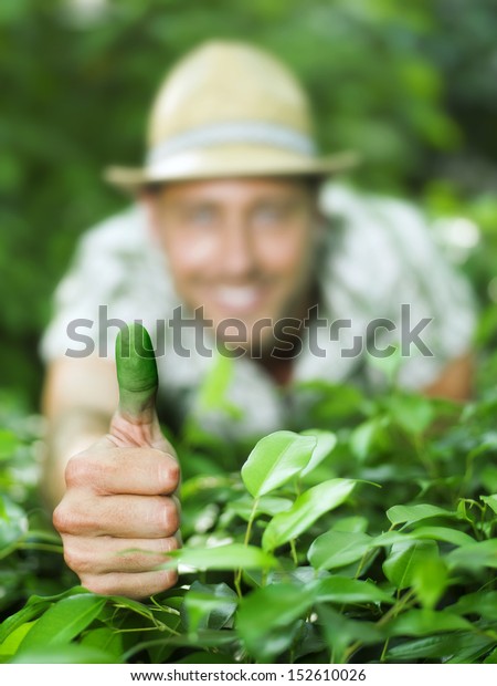 farmer shows his green\
thumb