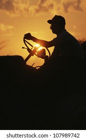 Farmer silhouetted by early morning sun