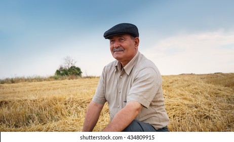 Farmer sitting in the field, waiting for his crop - Powered by Shutterstock