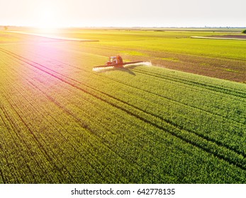 Farmer spraying green wheat field - Shutterstock ID 642778135