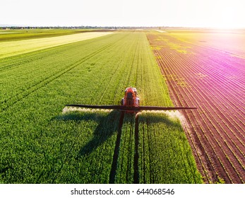 Farmer spraying green wheat field - Shutterstock ID 644068546