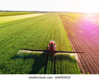 Farmer spraying green wheat field - Shutterstock ID 644903410