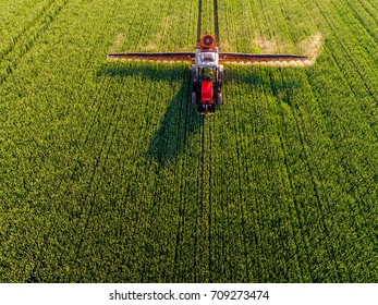 Farmer spraying green wheat field - Shutterstock ID 709273474