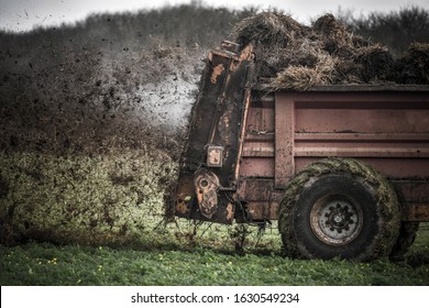 farmer spreading manure in the fields - Shutterstock ID 1630549234