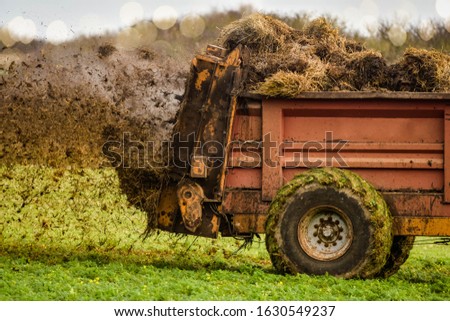farmer spreading manure in the fields