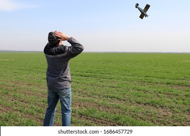 A Farmer Standing On His Wheat Field Sees A Small Plane Overhead About To Crash