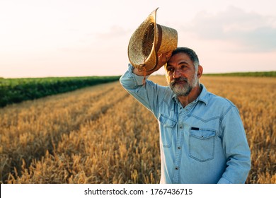 Farmer Standing In Wheat Field