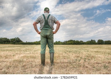 A farmer stands on his parched meadow and hopes for rain while the sun shines mercilessly on his farmland. Rising temperatures and too little rain the arable land in Germany is dry like never before.