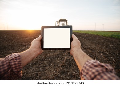 Farmer with tablet in field - Powered by Shutterstock