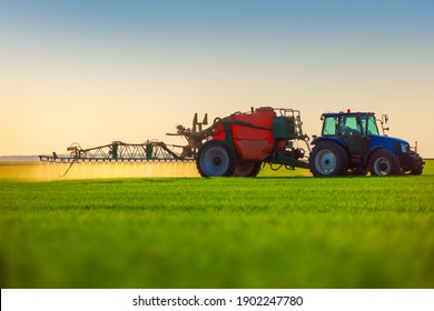 Farmer in tractor fertilizing wheat field,hdr nature landscape.