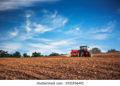 Farmer in tractor preparing farmland with seedbed for the next year