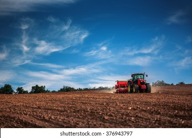 Farmer In Tractor Preparing Farmland With Seedbed For The Next Year