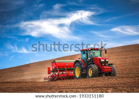 Farmer in tractor preparing farmland with seedbed for the next year