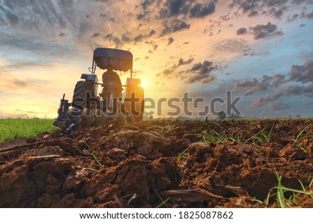 Farmer in tractor preparing land with seedbed cultivator as part of pre seeding activities in early spring season of agricultural works at farmlands Cultivated field Agronomy farming husbandry concept Imagine de stoc © 