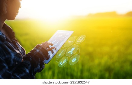 Farmer using iot digital tablet computer and modern interface icons, Business agriculture technology concept. - Shutterstock ID 2351832547