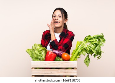 Farmer Woman holding fresh vegetables in a wooden basket whispering something