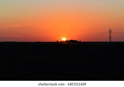 A Farmer Working On The Oklahoma Panhandle At Sunset