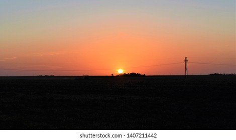 A Farmer Working On The Oklahoma Panhandle At Sunset