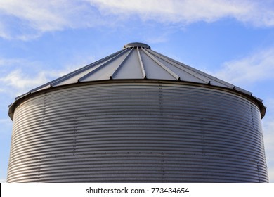 Farmer's Grain Bin Against A Blue Sky