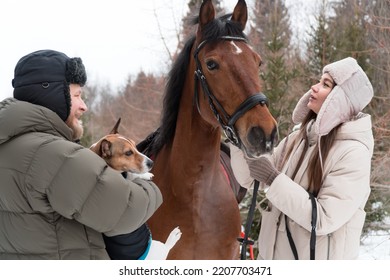 Farmers (man And Woman) Walking With Dog And Horse In Winter Day In Countryside