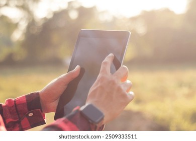 Farmers are using tablets to record data on their farm. Solar farm, smart farm, data collection