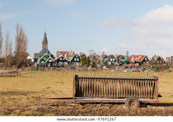 Farmers\
wagon in front of typical Dutch village\
Marken