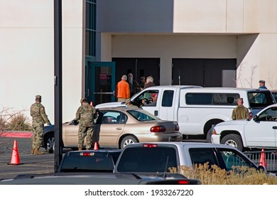 Farmington, New Mexico USA-March 10th 2021: Police Army National Guard Directing Covid 19 Corona Virus Vaccine Recipients To Parking And Pre Screening Tests.