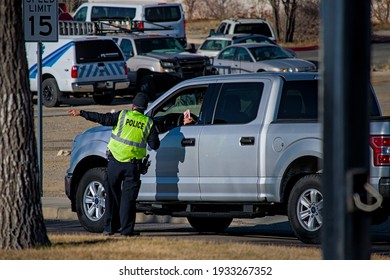 Farmington, New Mexico USA-March 10th 2021: Police Army National Guard Directing Covid 19 Corona Virus Vaccine Recipients To Parking And Pre Screening Tests.