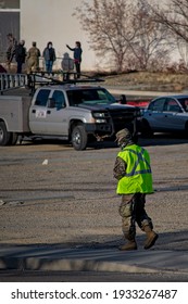 Farmington, New Mexico USA-March 10th 2021: Police Army National Guard Directing Covid 19 Corona Virus Vaccine Recipients To Parking And Pre Screening Tests.