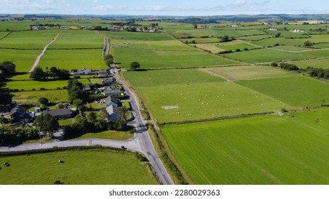 Farmland in the Ireland on a sunny summer day. Picturesque agricultural landscape, top view. Rural area. Green grass field and animals on the pasture - Powered by Shutterstock