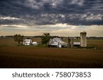 Farmstead Under Clouds - clouds making their way past a farm